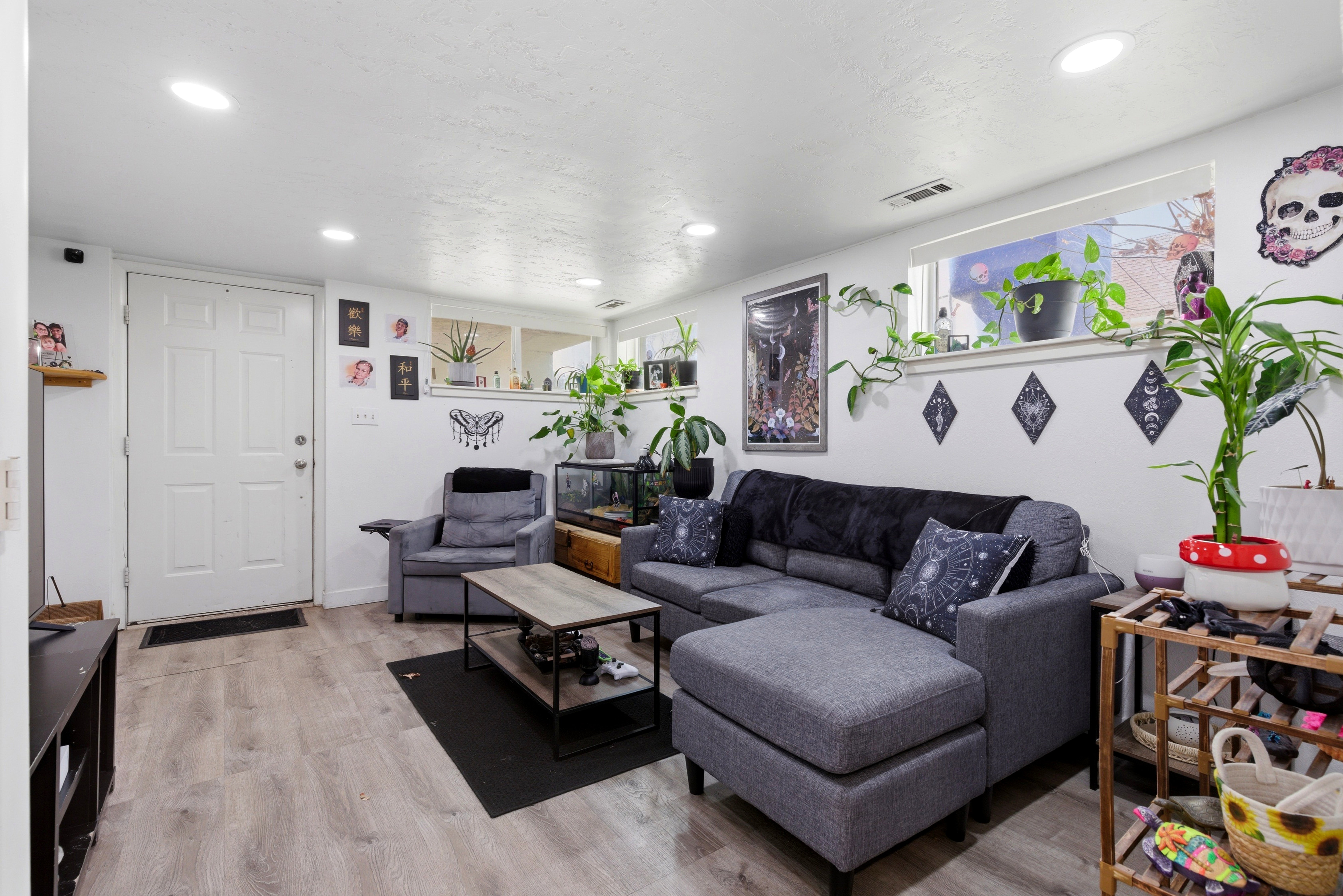 Basement living room featuring light wood-style flooring and recessed lighting