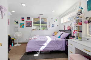 Bedroom with recessed lighting and light colored carpet