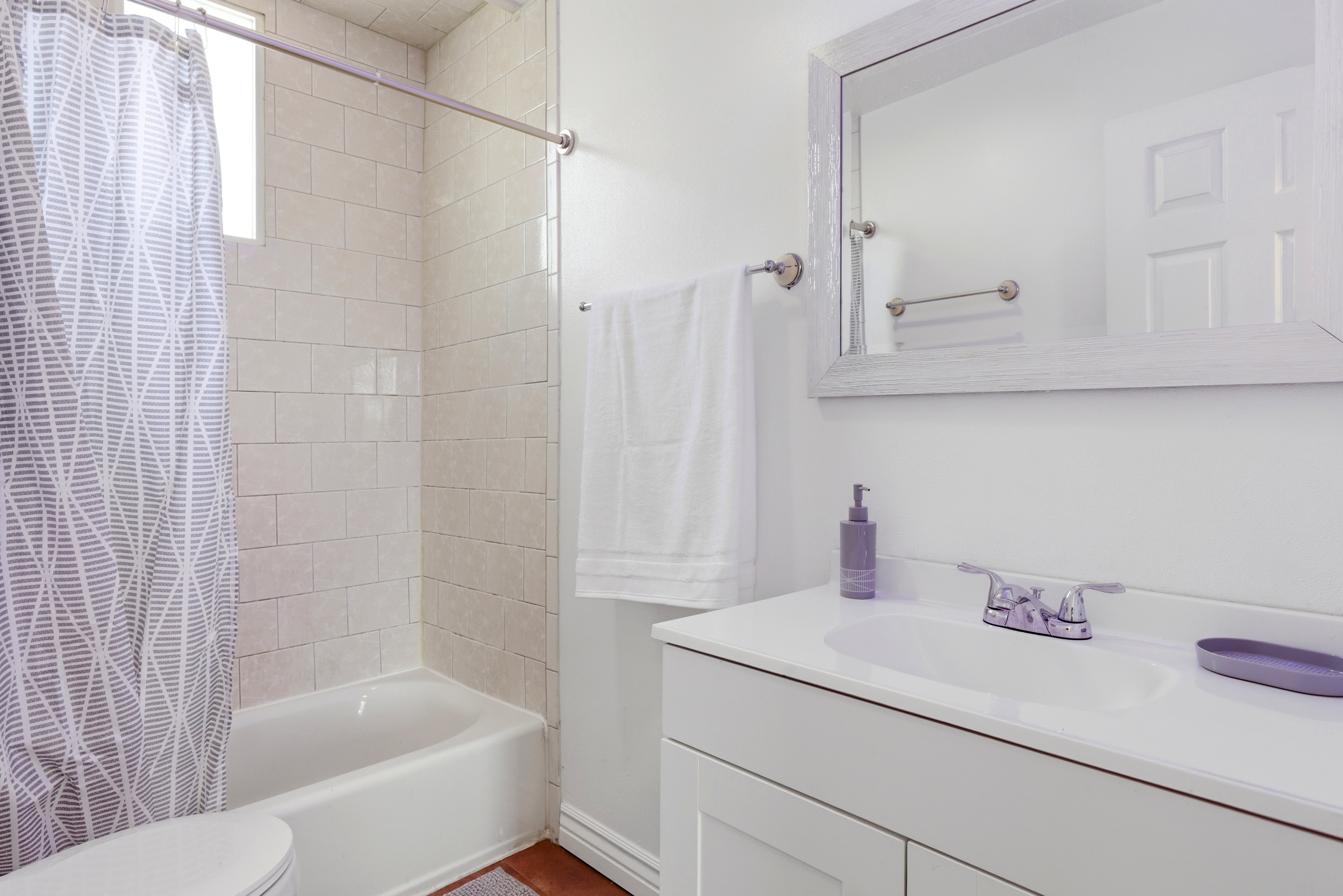 Full bath featuring vanity and shower / tub combo with curtain