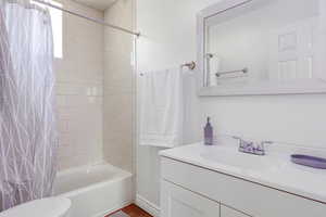 Full bath featuring vanity and shower / tub combo with curtain