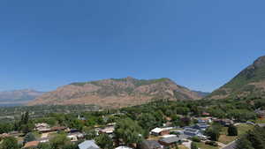 View of mountain backdrop featuring nearby suburban area