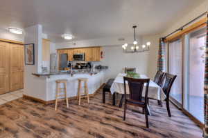 Dining room featuring hanging lights and dark wood-type flooring