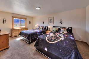 Bedroom featuring light carpet and baseboards
