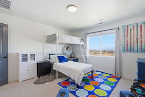 Bedroom featuring light colored carpet and baseboards