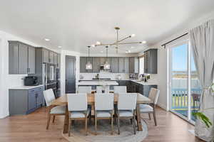 Dining room featuring light wood-style flooring and suspended lighting