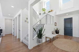 Entrance foyer featuring light wood-type flooring, recessed lighting, and a high ceiling