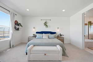 Bedroom with light colored carpet and recessed lighting