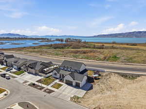 Aerial perspective of suburban area with a water and mountain view