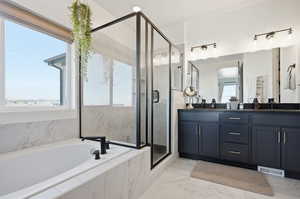Full bath with double vanity, a marble finish shower, a garden tub, and light marble finish flooring