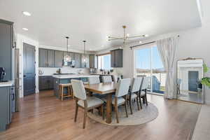 Dining area featuring light wood-style flooring and suspended lighting