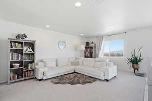 Living area featuring carpet floors and recessed lighting