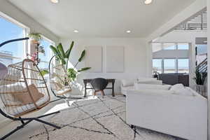 Living area featuring baseboards and recessed lighting