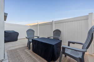 Fenced backyard with a grill and a patio area