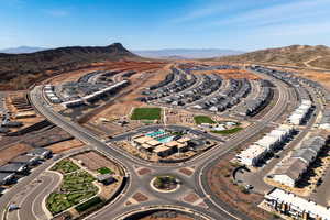 Aerial view of property's location with a mountainous background and nearby suburban area