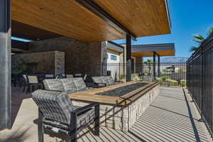 View of patio featuring an outdoor living space with a fire pit