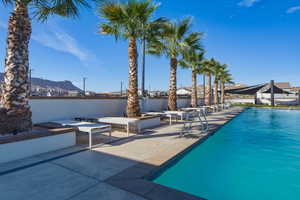 Community pool with a mountain view and a patio