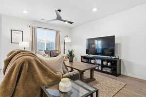 Living area featuring ceiling fan, wood finished floors, and recessed lighting