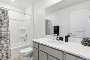 Full bathroom featuring vanity, light wood-type flooring, and shower / bath combination with curtain