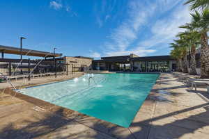 Community pool with a patio
