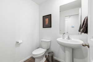 Bathroom with toilet and dark wood-style floors