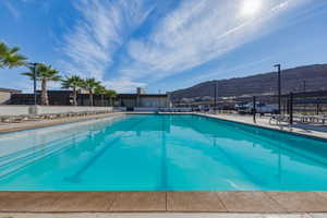 Community pool featuring a mountain view and a patio area