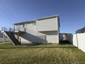 Rear view of house featuring Brand New TREX Deck stairs to your large backyard