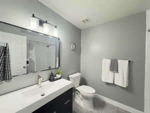 Hallway Bathroom with vanity, recently upgraded light tile patterned floor