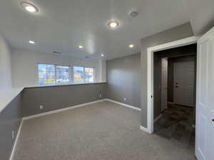 Bedroom (4) light colored carpet and canned lighting with a Walk-in closet