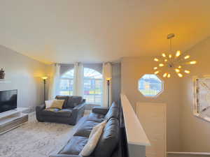 Living room featuring entrance hanging lights and plenty of natural light