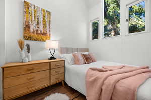 Bedroom with dark wood-style flooring and vaulted ceiling