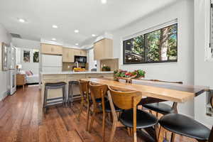 Dining area featuring dark wood-style floors and recessed lighting