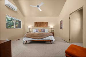 Bedroom with vaulted ceiling, a closet, light colored carpet, and ceiling fan