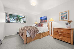 Bedroom featuring carpet floors and baseboards