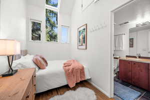 Bedroom with dark wood-style flooring and a sink