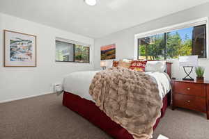 Carpeted bedroom featuring baseboards