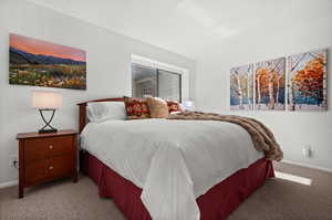 Carpeted bedroom with baseboards