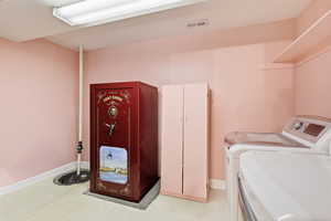 Laundry area with light floors and washing machine and dryer