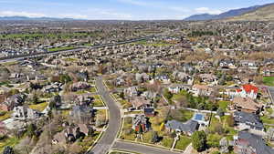 Aerial view of property's location featuring a mountainous background and nearby suburban area