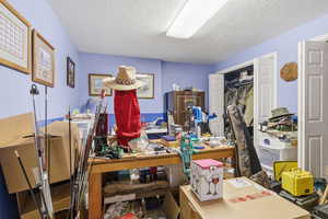 Miscellaneous room featuring a textured ceiling
