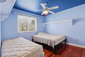 Bedroom with wood finished floors and ceiling fan