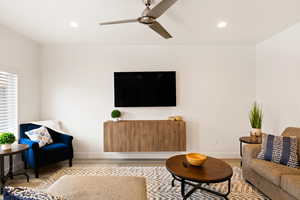 Living area with wood finished floors, ceiling fan, and recessed lighting