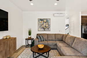Living area featuring wood finished floors, recessed lighting, and a ceiling fan