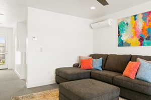 Living area with carpet flooring, recessed lighting, and ceiling fan