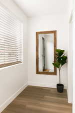 Spare room with dark wood-style floors and baseboards