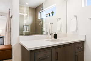 Full bath with vanity and a stall shower