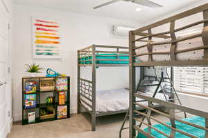 Bedroom with light colored carpet, a ceiling fan, and recessed lighting