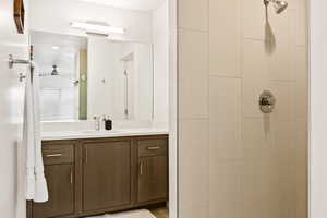 Full bathroom with vanity and a tile shower