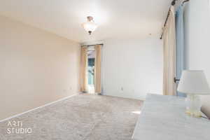 Carpeted bedroom featuring baseboards