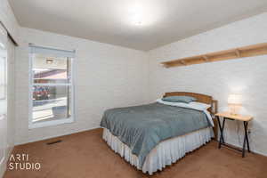 Carpeted bedroom featuring a closet