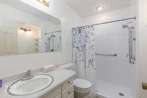 Full bathroom featuring vanity and a shower stall